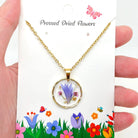 Dried flowers in an irregular round pendant necklace from The Bullish Store, showcasing a nature-inspired jewelry design.