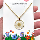 Dried flowers in an irregular round pendant necklace by The Bullish Store, featuring natural floral design for nature lovers.