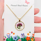 Dried flowers in an irregular round pendant necklace by The Bullish Store, featuring nature-inspired fashion jewelry design.