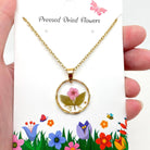 Dried flowers in an irregular round pendant necklace with natural floral design, stylish jewelry for nature lovers.