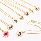 Dried flowers in a round pendant necklace from The Bullish Store, featuring a nature-inspired floral design and irregular shape.
