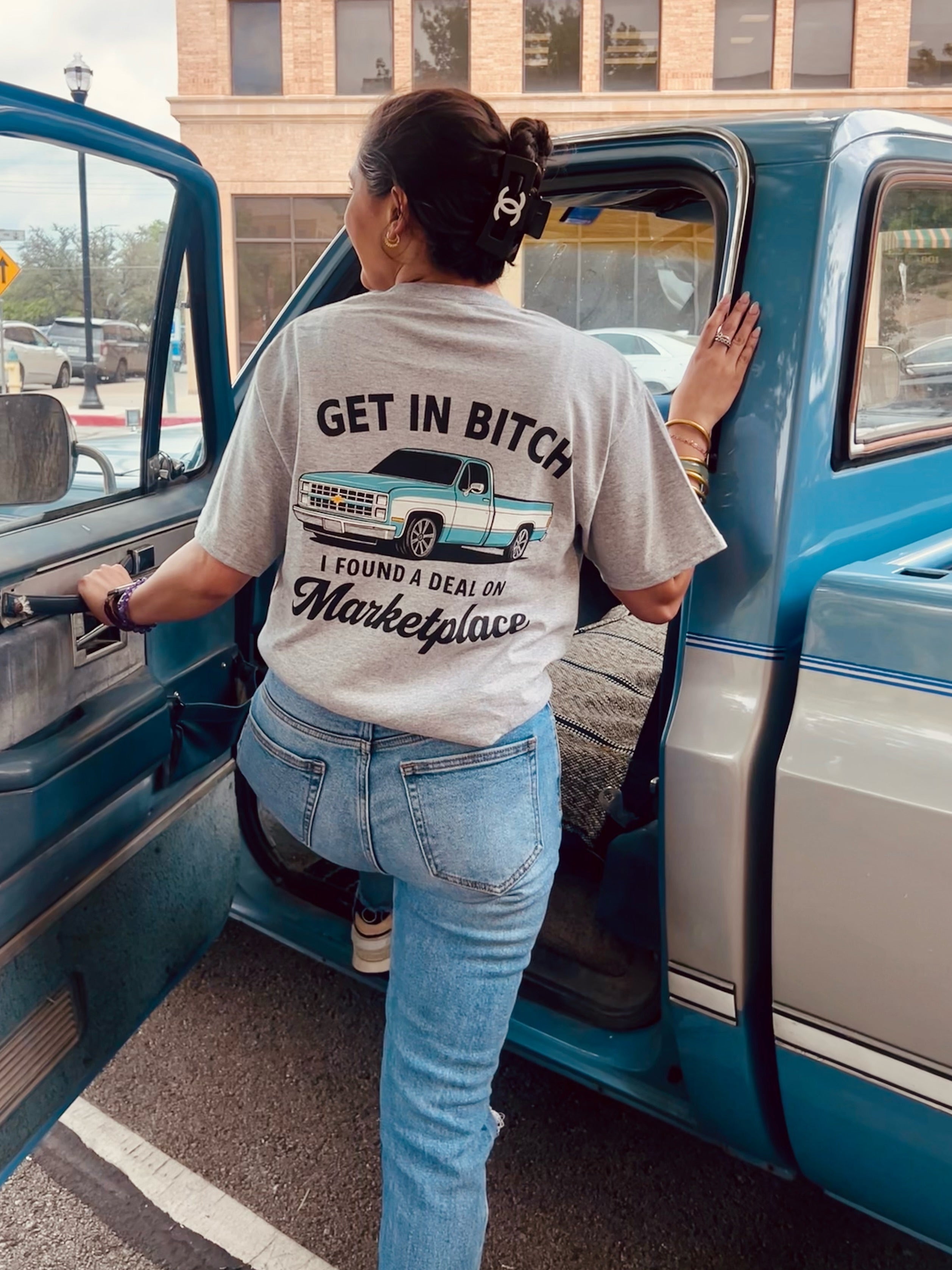 Blue Chevy car with "Get In B*tch, I found a deal on Marketplace" graphic T-shirt by Shop Karma Tees displayed in the image.