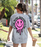 It's Fine Smiley graphic T-shirt by Shop Karma Tees featuring a cheerful yellow smiley face on a casual white tee.
