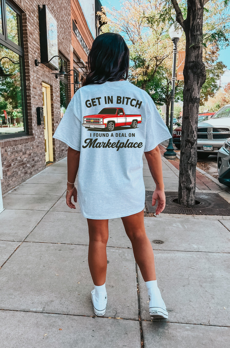 Shop Karma Tees "Get In B*tch, I Found a Deal" graphic T-shirt displayed on a person, showcasing bold text and casual style.