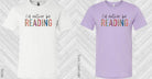Black graphic tee from Anchored Grace Boutique featuring the phrase "I'd Rather Be Reading" in stylish lettering.