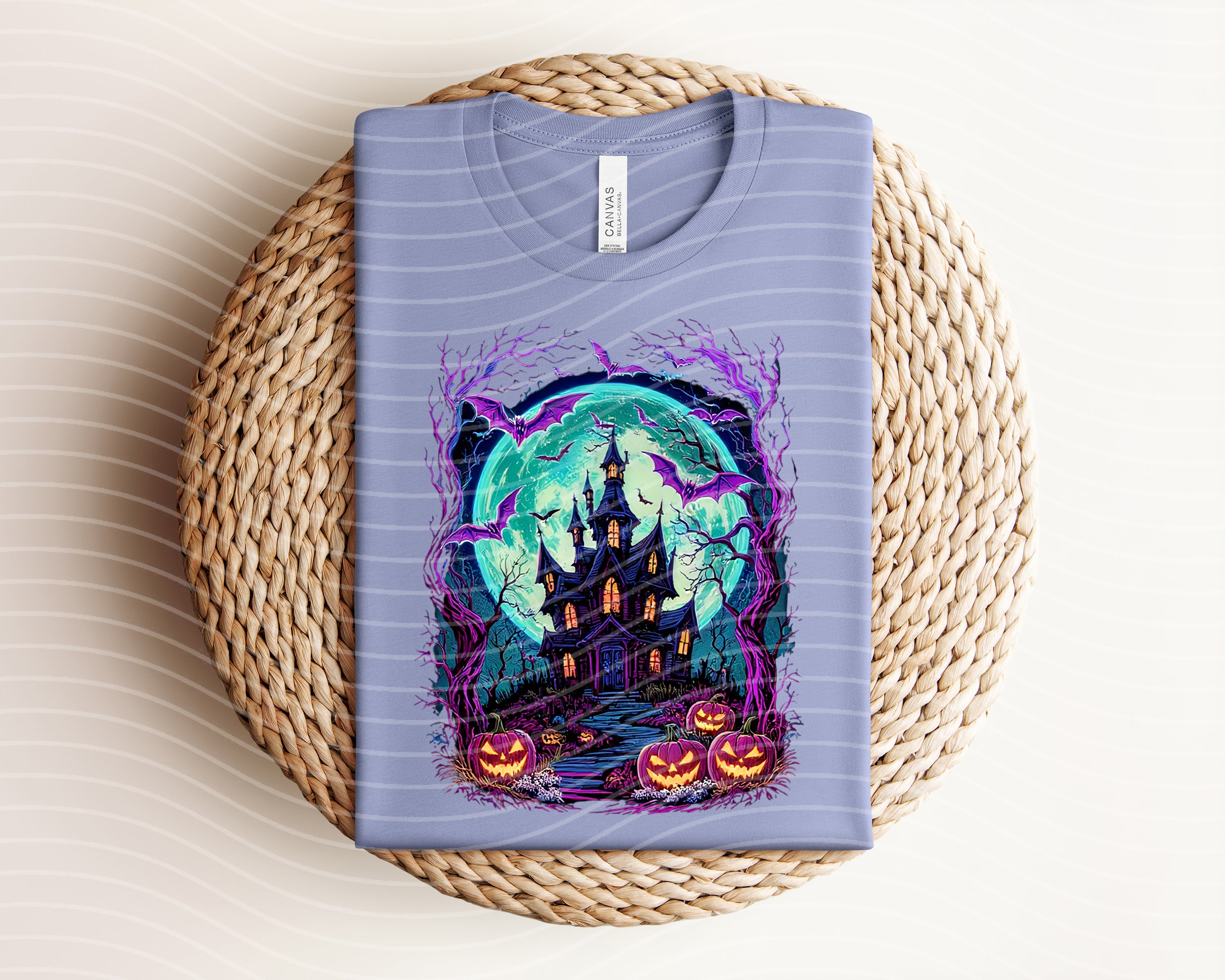 Spooky House graphic tee by Anchored Grace Boutique featuring a Halloween-themed haunted house design on a casual t-shirt.
