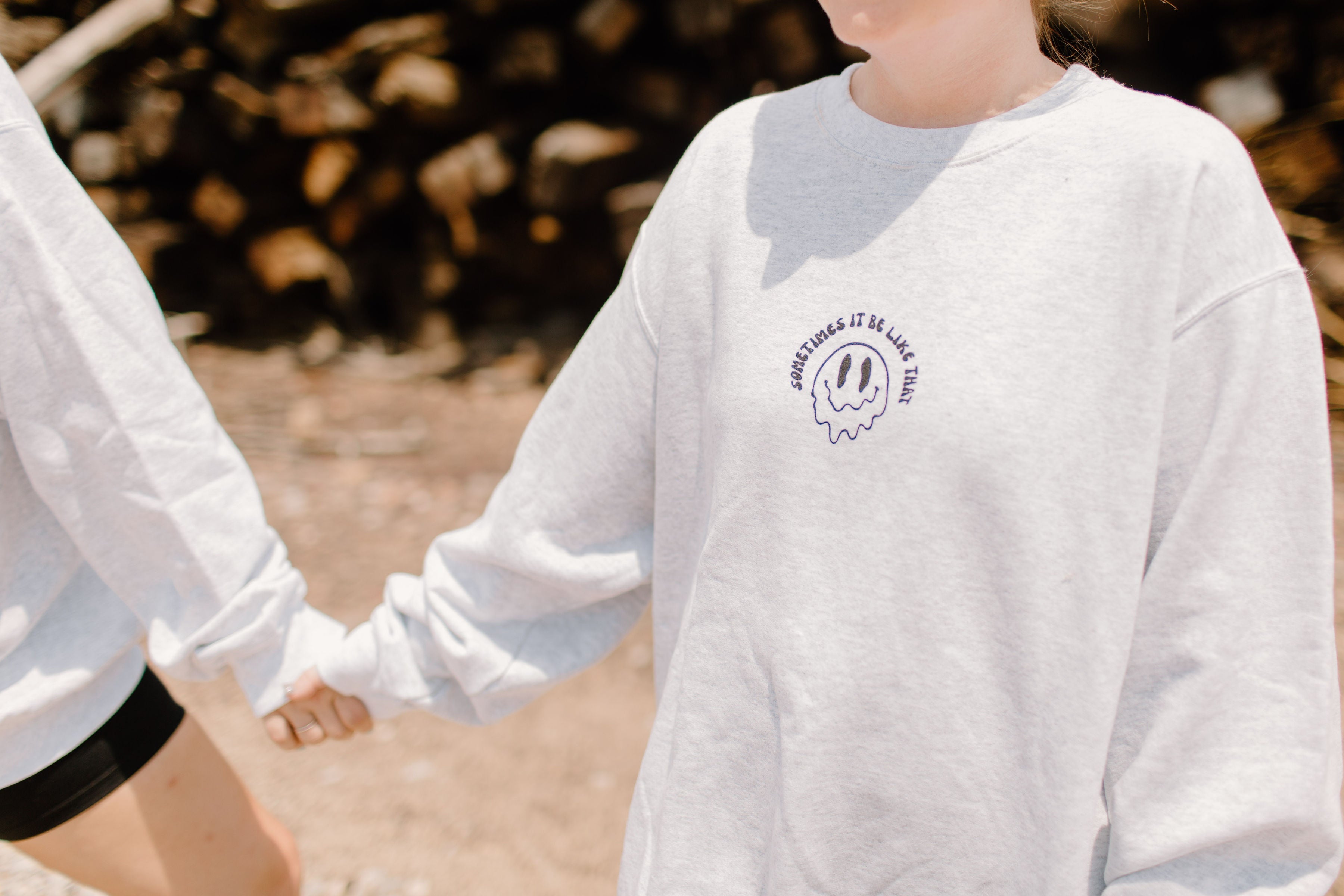 Cream-colored crewneck sweatshirt by Shop Karma Tees featuring the "Sometimes it be like that" slogan in casual style.