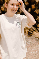 Black graphic t-shirt featuring coffee cups and conspiracy theory illustrations, by Shop Karma Tees.