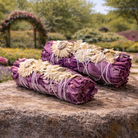 Purple smudge stick for cleansing rituals, featuring vibrant purple herbs and natural dried plant materials.