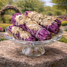 Purple smudge stick from Practical Magic Store, showing a bundle of dried herbs and purplesmudge sticks for cleansing rituals.