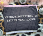 Black graphic tee with "My Book Boyfriend is Better Than Yours" quote from Anchored Grace Boutique, casual wear for book lovers.