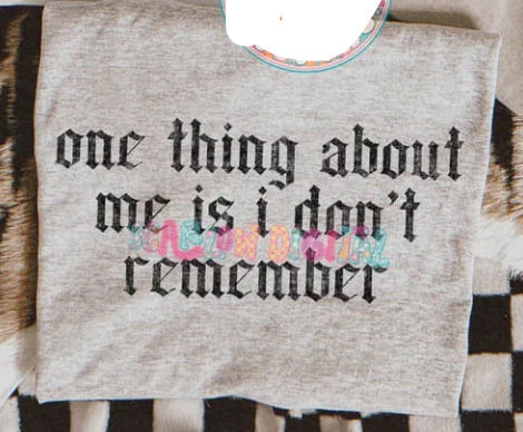 Black graphic tee from Anchored Grace Boutique featuring the phrase "One Thing About Me Is I Don't Remember" in bold white text.