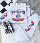 Vintage Team Patriots graphic tee by Anchored Grace Boutique featuring a retro sports design and bold Patriots logo.