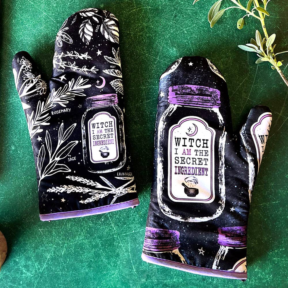 Set of 2 witch-themed oven mitts and pot holders with hanging loops, featuring "I AM The Secret Ingredient" design from The Bullish Store.