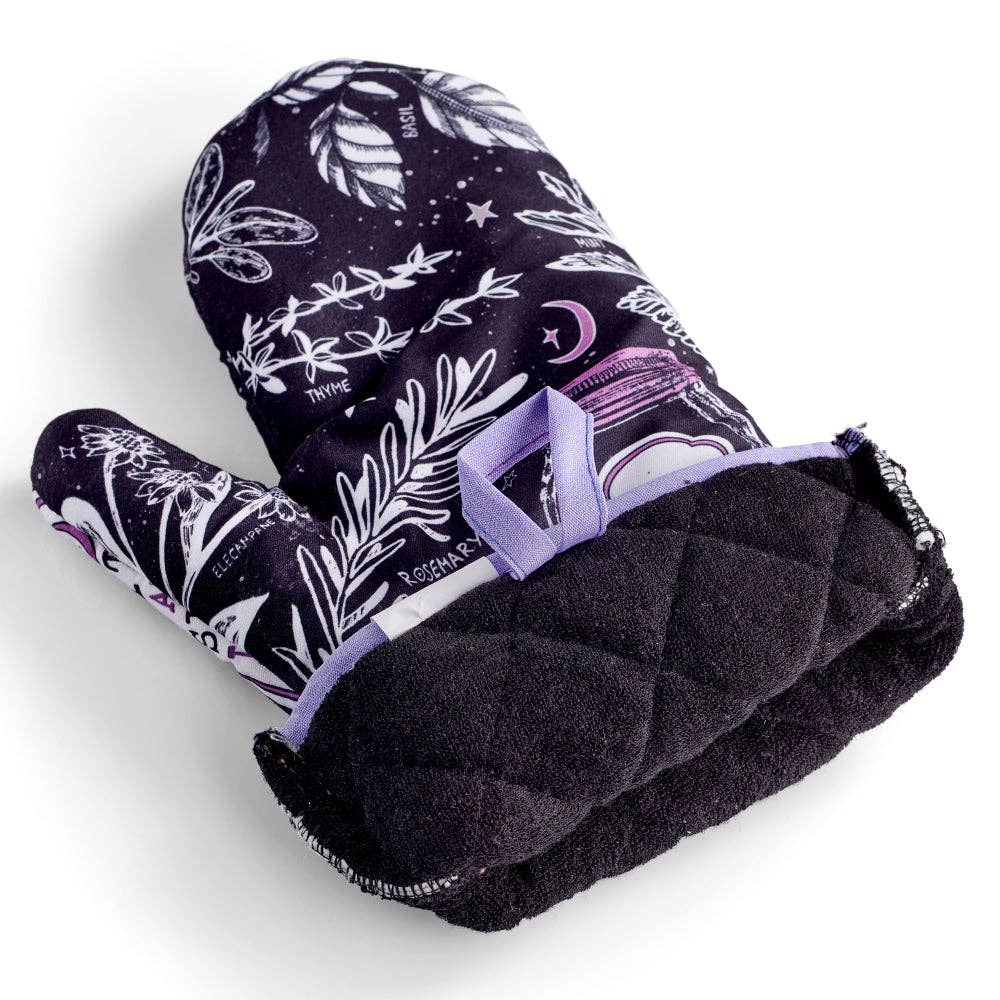 Set of 2 witch-themed oven mitts and pot holders from The Bullish Store, hanging and featuring "I AM The Secret Ingredient" design.