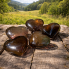 Smoky quartz heart gemstone from Practical Magic Store, polished and smooth with natural smoky gray color.