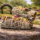 Practical Magic Store floral smudge stick with vibrant dried flowers and herbs, perfect for cleansing and spiritual rituals.