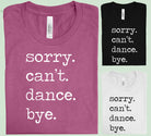 Black graphic tee by Anchored Grace Boutique featuring the playful "Sorry Can't Dance Bye" slogan on the front.