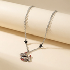 Sourpuss "Good Luck" horseshoe necklace with red rhinestones and black star charms on a silver chain.