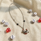 Sourpuss "Good Luck" horseshoe necklace with red rhinestones and black star charms, featuring a stylish and lucky jewelry design.
