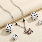 Sourpuss "Good Luck" horseshoe necklace with red rhinestones and black star charms, featuring a stylish black chain.