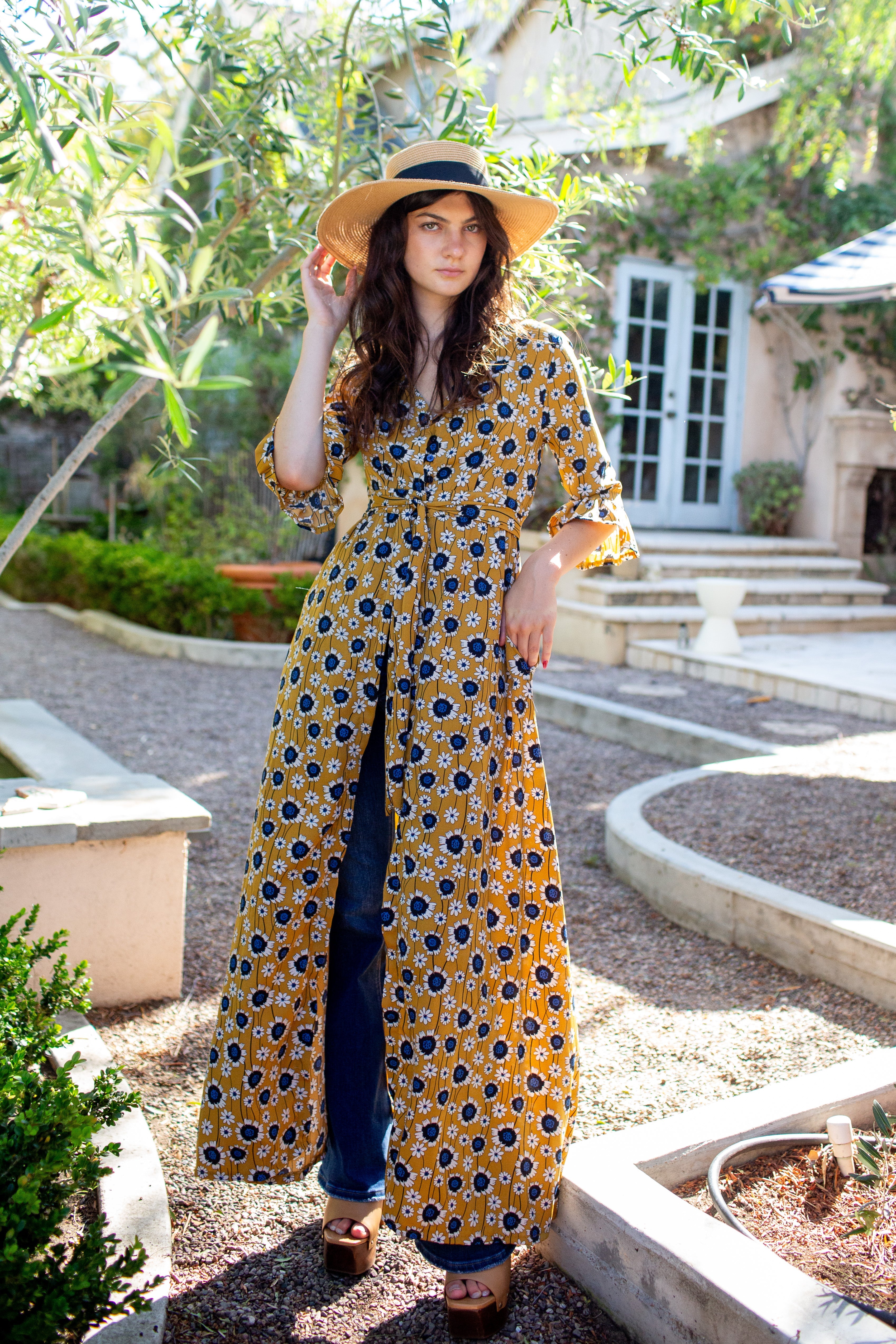 Gold sunflower dressing gown by Jennafer Grace, featuring a floral pattern and soft fabric, shown on a model.