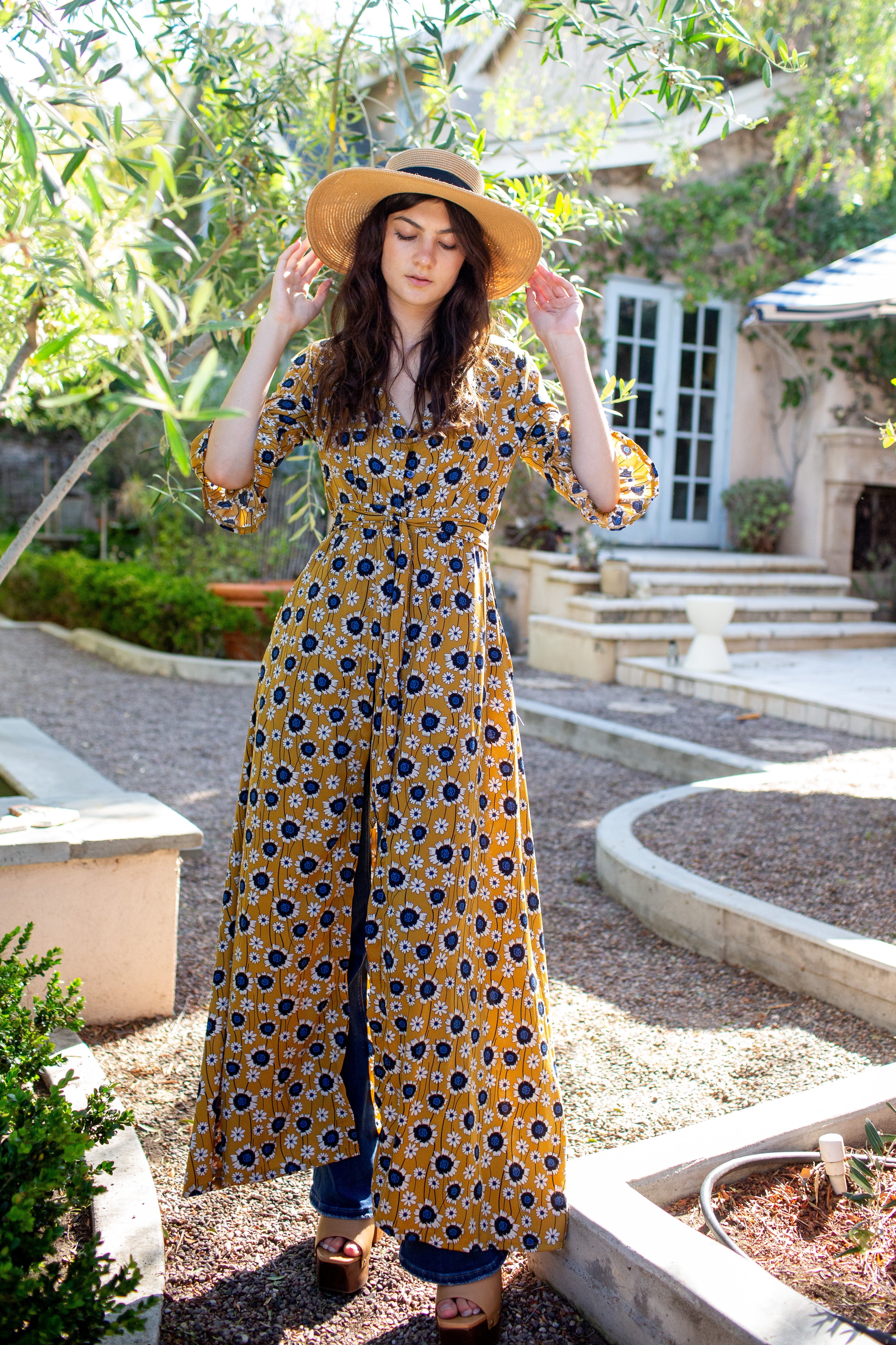 Gold sunflower dressing gown by Jennafer Grace, featuring a soft fabric and floral sunflower pattern, displayed on a hanger.