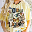 Pink "One More Chapter" graphic tee by Anchored Grace Boutique, casual t-shirt with book-themed design.