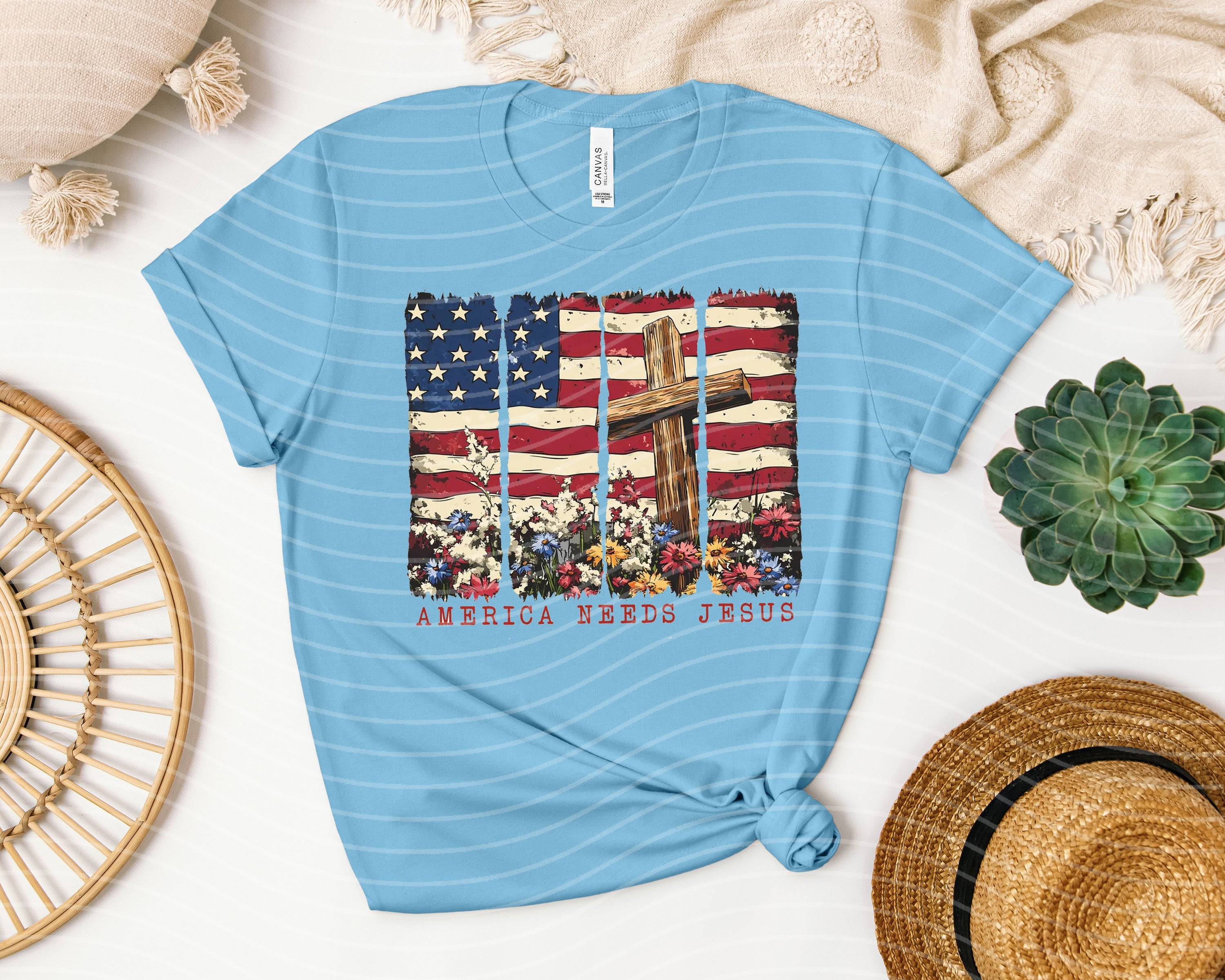 America Needs Jesus graphic tee by Anchored Grace Boutique, featuring bold religious message on a casual t-shirt.