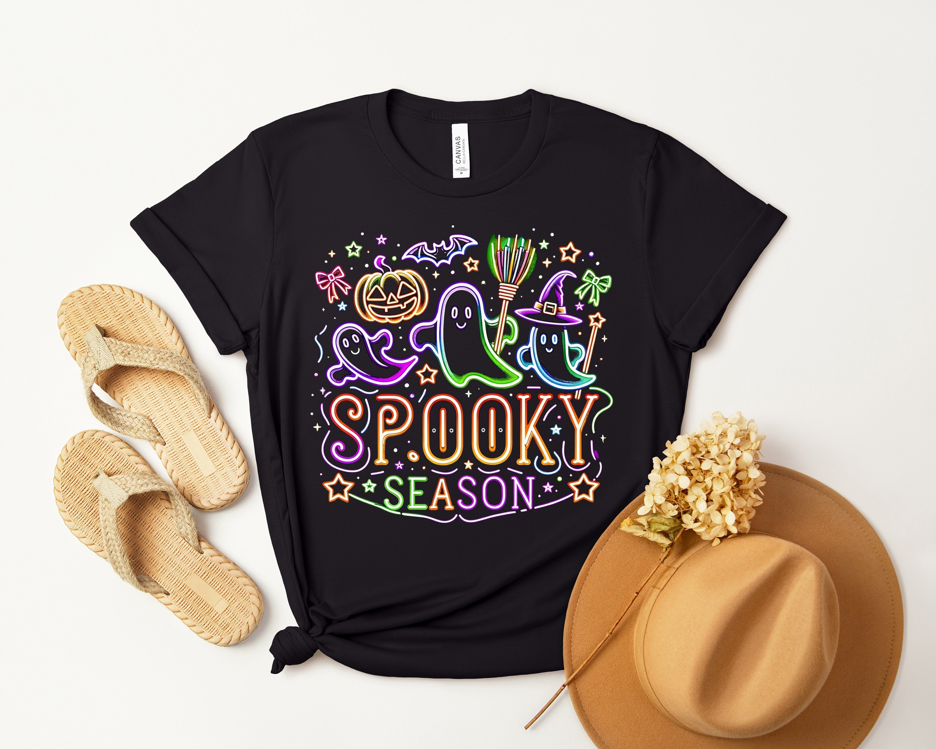 Spooky Season graphic tee by Anchored Grace Boutique featuring Halloween-themed design on black cotton fabric.