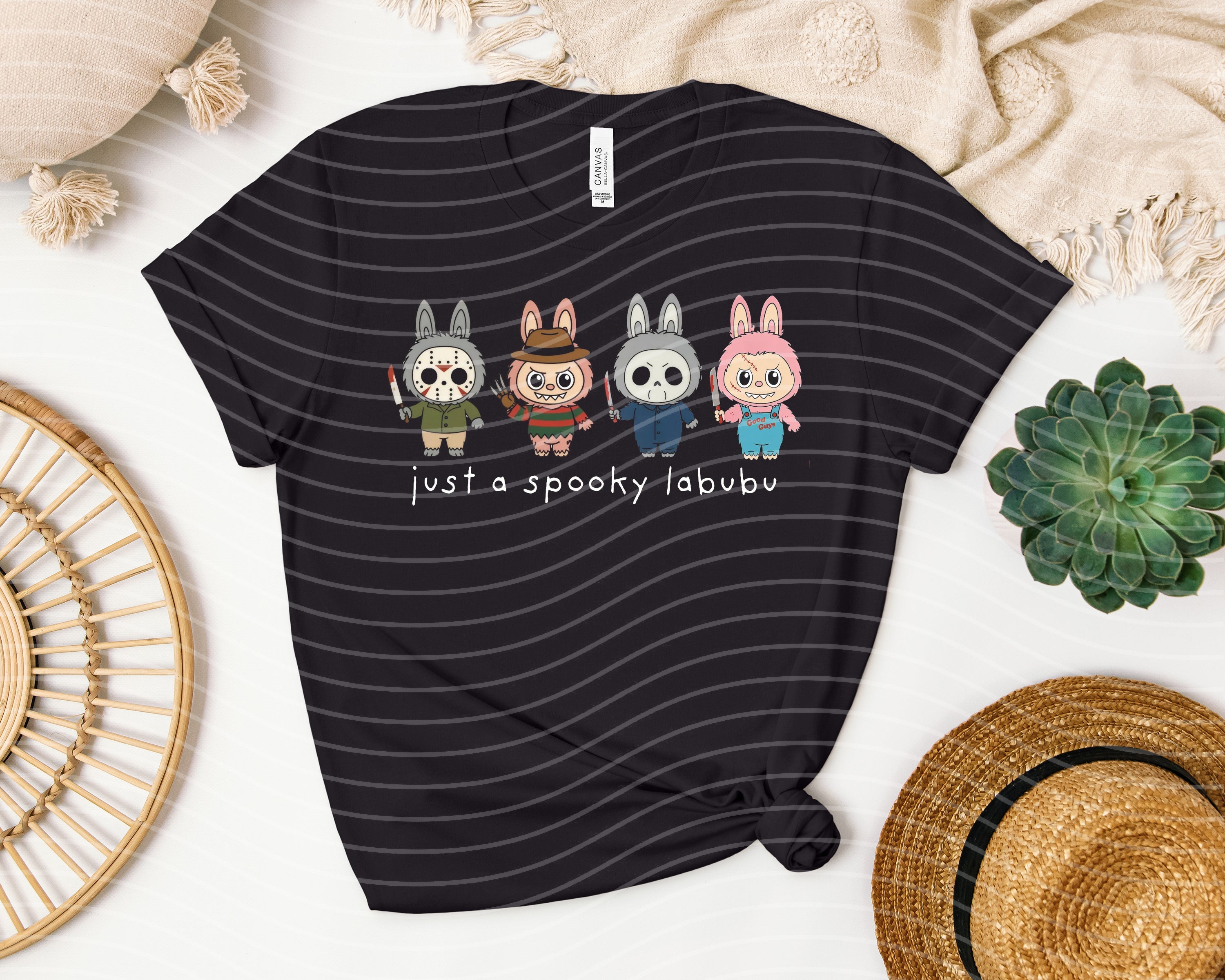 Black graphic tee featuring a spooky Labubu design from Anchored Grace Boutique, with vibrant Halloween-themed artwork.
