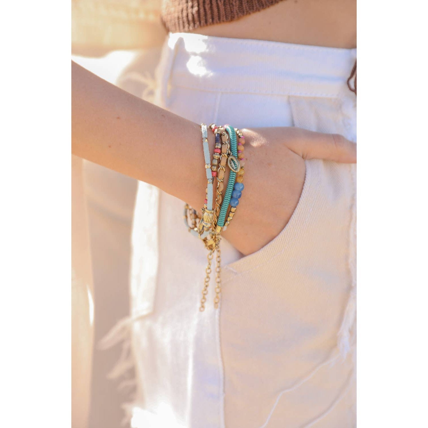 Stack of five teal multi-suede bracelets showcasing boho layering jewelry with vibrant colors and textured suede bands.