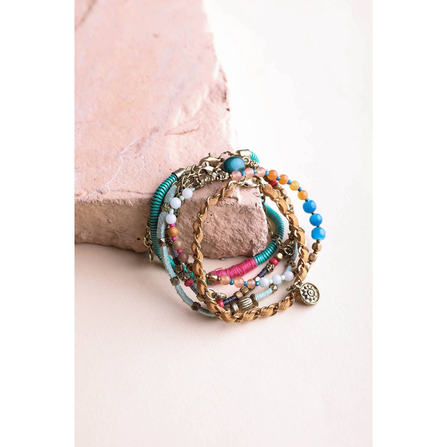 Stack of five teal multi-suede boho bracelets with layered designs, perfect for layering jewelry styles.
