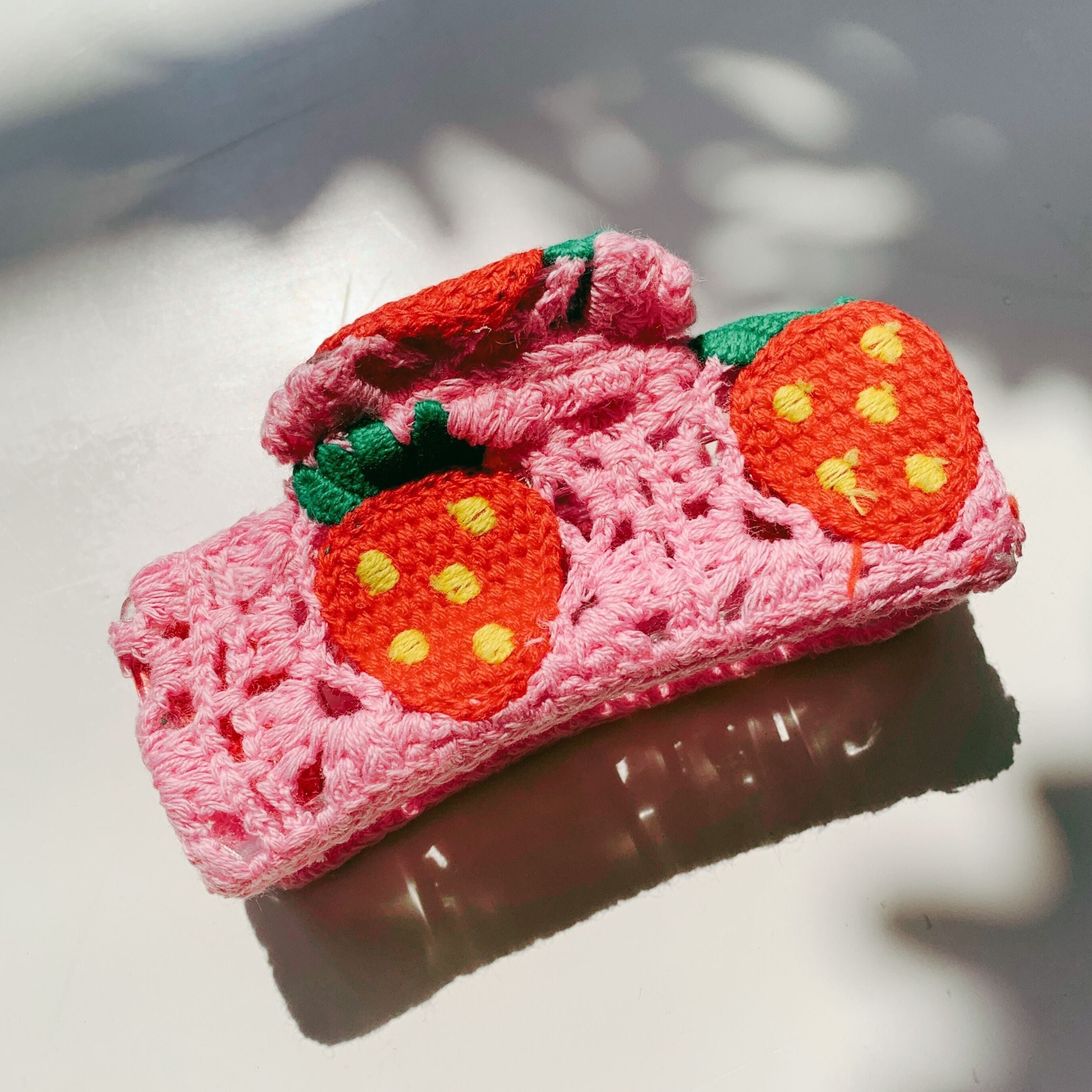 Velvet Claws strawberry granny square hair claw accessory from The Bullish Store, featuring soft fabric and retro crochet design.