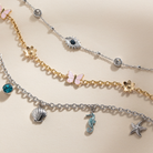 Gold stainless steel butterfly and flower anklet by ALEX AND ANI featuring delicate charm designs on a thin chain.