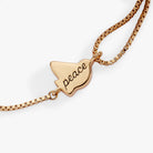 Alex and Ani Dove 'Peace' mother of pearl pull chain bracelet featuring gold accents and a peaceful dove charm.