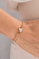 Alex and Ani Dove 'Peace' Mother of Pearl pull chain bracelet featuring gold accents and elegant design.