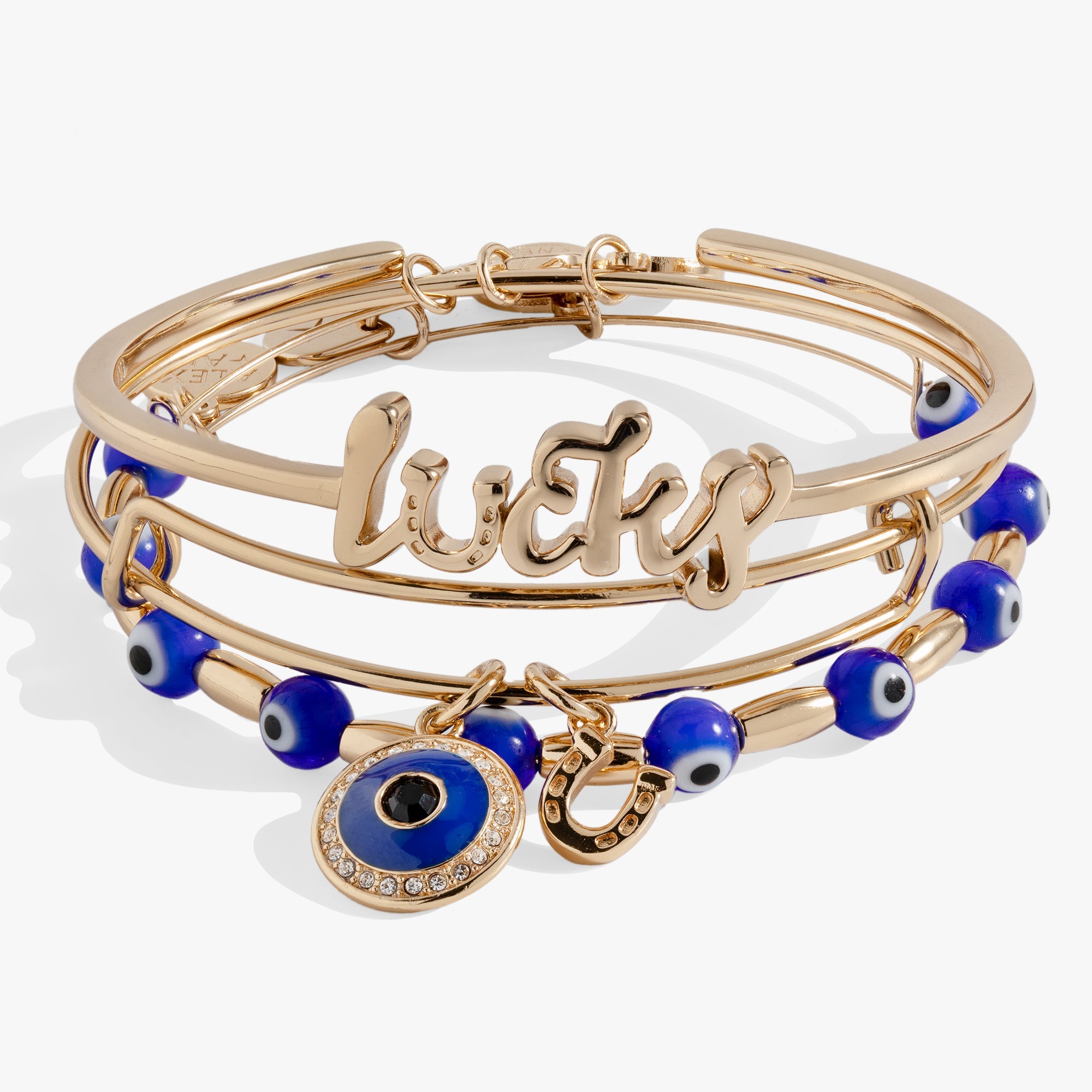 Set of three gold evil eye bangles by ALEX AND ANI, featuring intricate designs and symbolic protective charms.