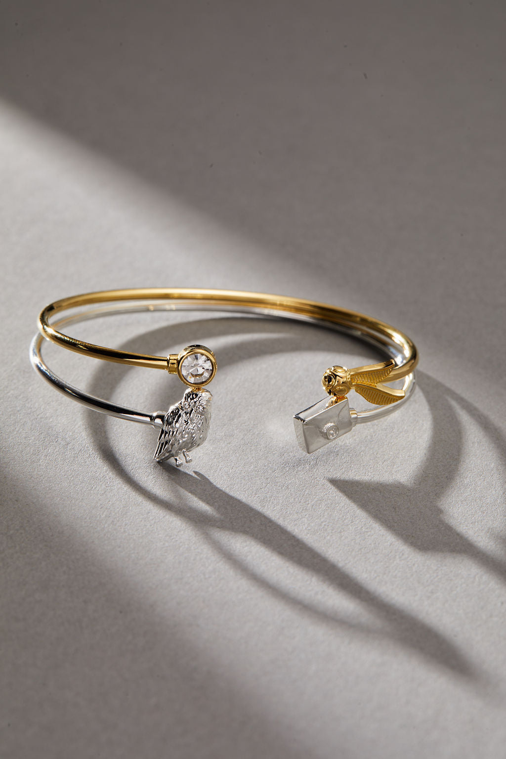 ALEX AND ANI Harry Potter™ Golden Snitch and Crystal Flex Cuff bracelet with gold-tone finish and intricate details.