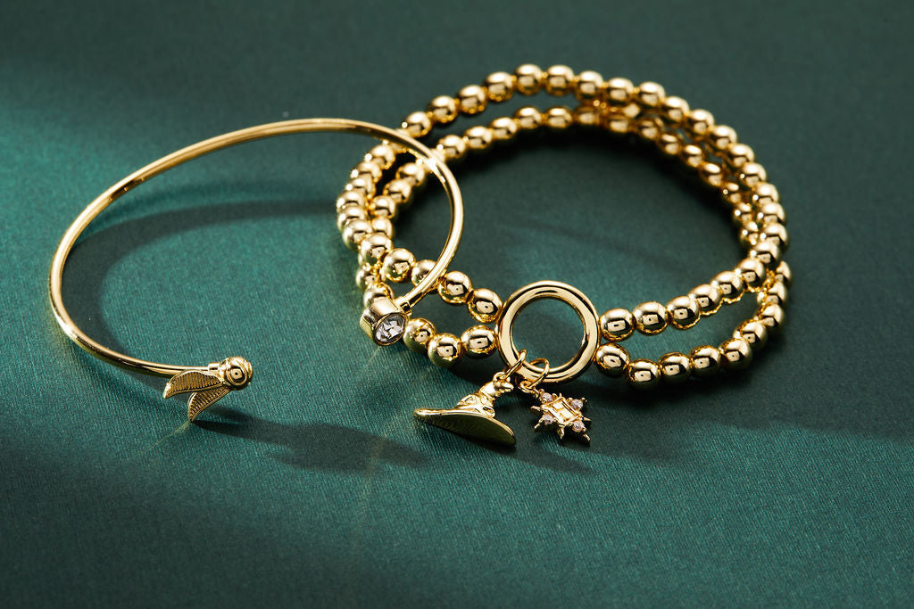 Gold Harry Potter Golden Snitch bracelet with crystal Flex Cuff by ALEX AND ANI, featuring intricate details and a sleek design.