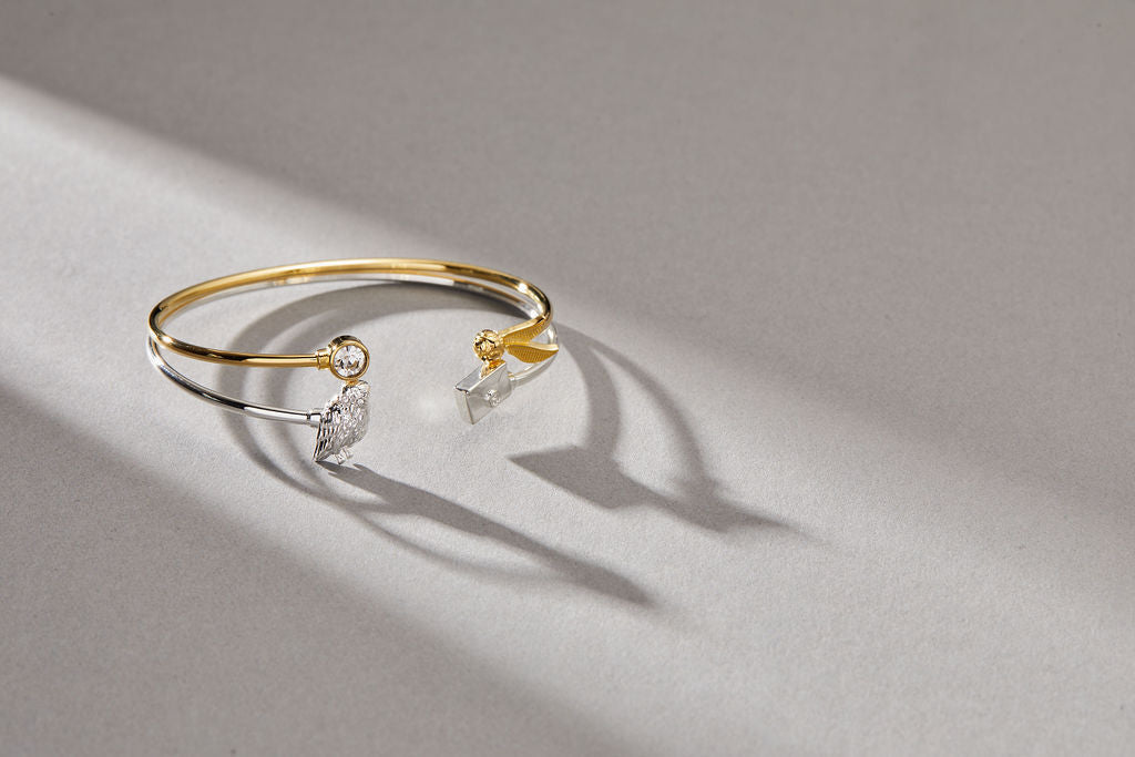 Gold Harry Potter™ Golden Snitch bracelet with crystal flex cuff by ALEX AND ANI, featuring intricate charm and elegant design.
