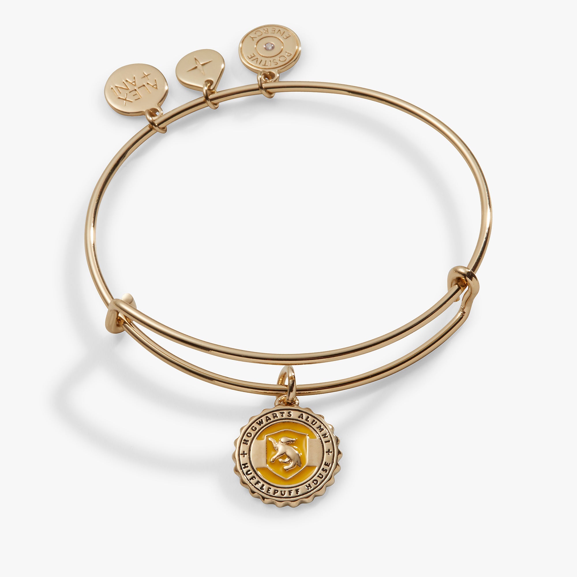Gold Harry Potter Hufflepuff House charm bangle bracelet by ALEX AND ANI featuring a detailed Hufflepuff crest charm.