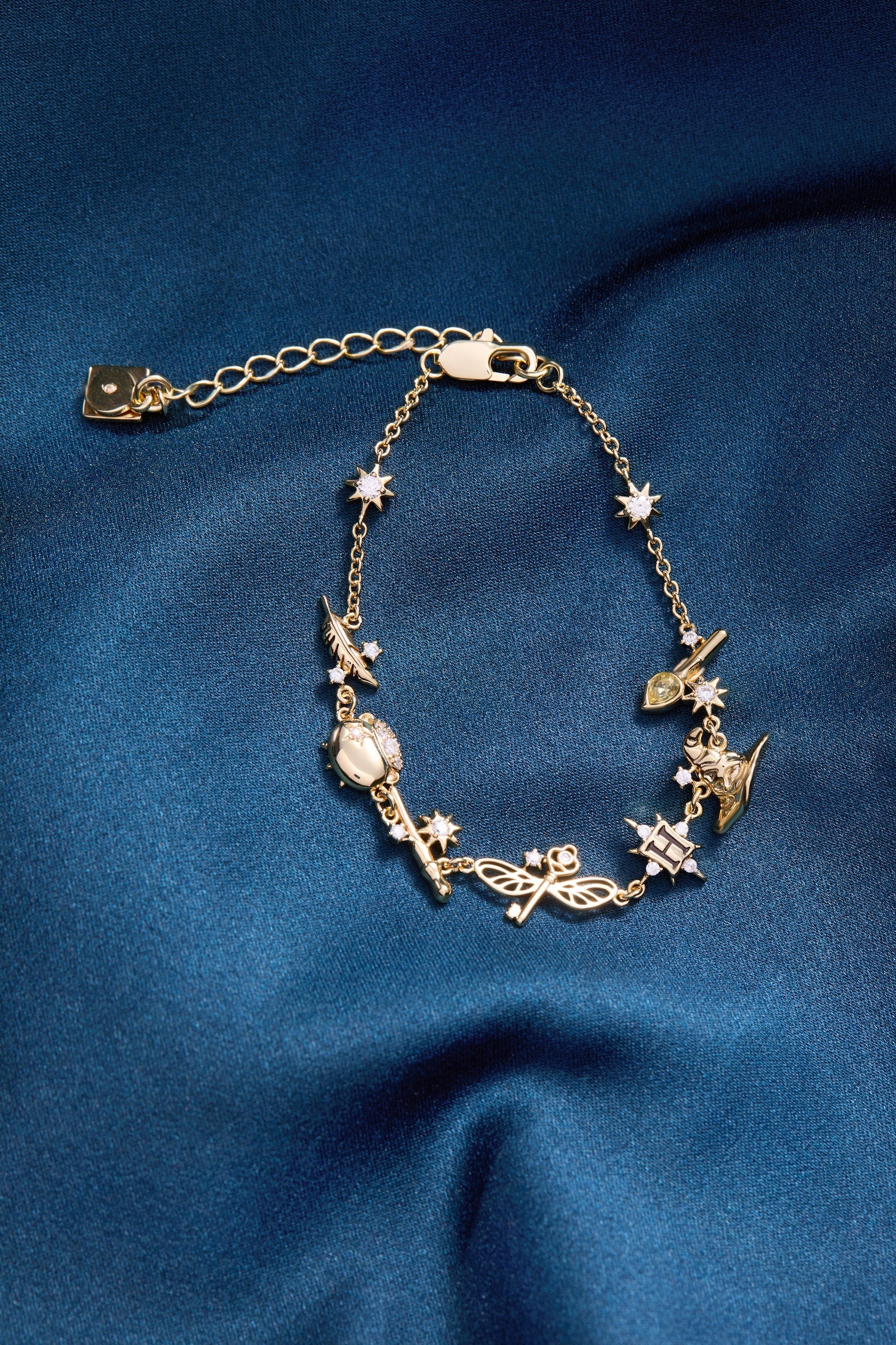 Gold Harry Potter™ Mixed Icon Inline Charm Bracelet by ALEX AND ANI featuring magical themed charms and intricate design.