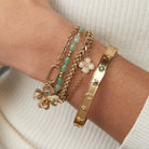 Gold ALEX AND ANI Lucky Hinge Bangle bracelet with a sleek, hinged design and engraved charm for elegant wristwear.