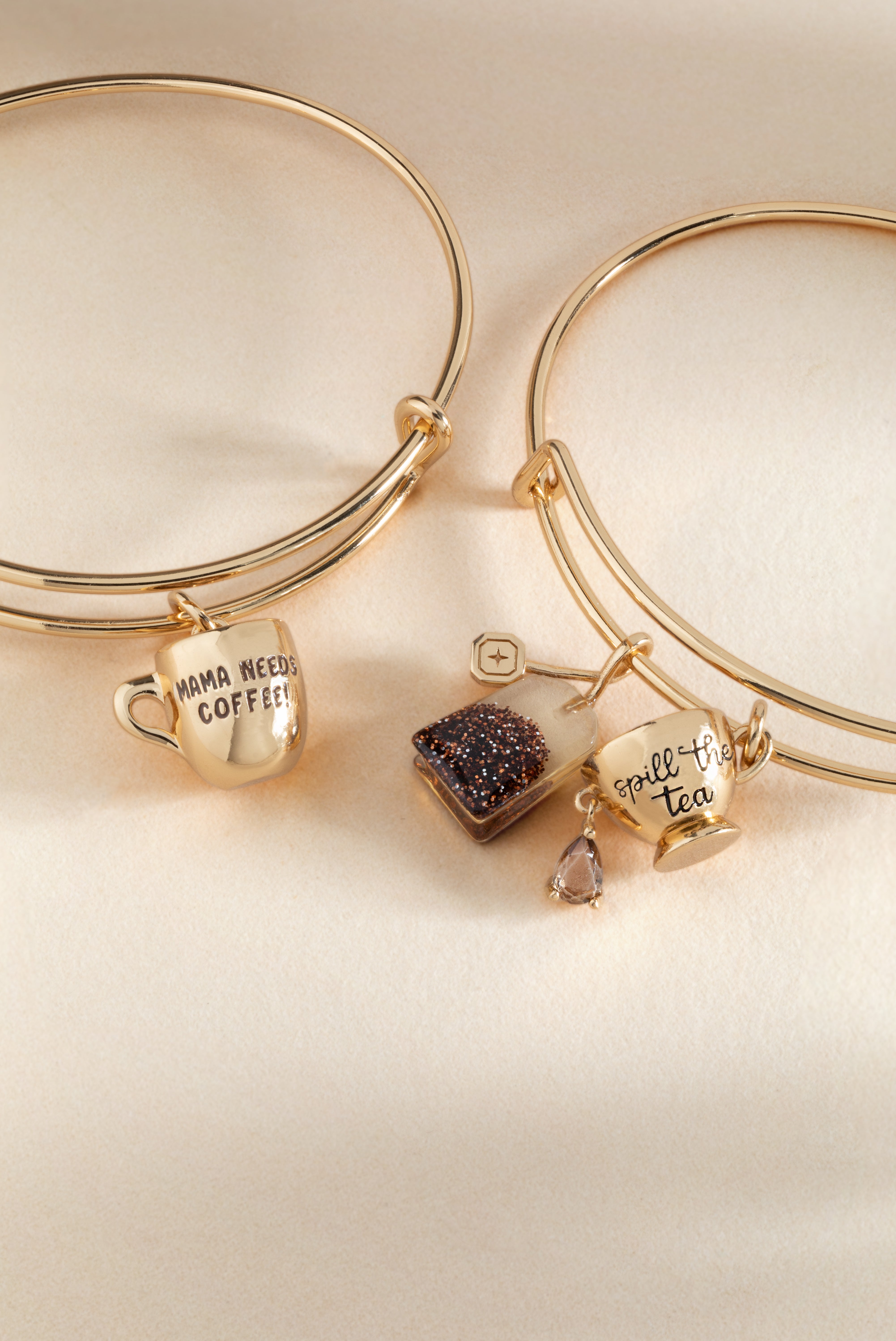 Gold ALEX AND ANI Spill the Tea bracelet with a cup and tea bag charm, featuring elegant jewelry design.