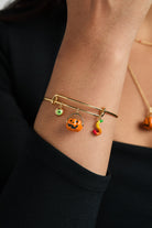Gold 'Trick or Treat' multi charm bangle bracelet by ALEX AND ANI featuring festive Halloween-themed charms.