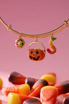 Gold 'Trick or Treat' multi charm bangle bracelet by ALEX AND ANI featuring Halloween-themed charms and intricate design.