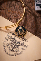 ALEX AND ANI Harry Potter Hogwarts Castle charm bangle with gold finish and detailed Hogwarts castle design.
