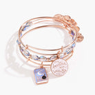 Set of three shiny rose gold Harry Potter Hermione 'Leviosa' bangles by ALEX AND ANI, featuring magical-themed bracelet designs.