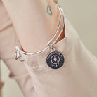Shiny silver Harry Potter Alohomora charm bangle bracelet by ALEX AND ANI with engraved magical lock symbol.